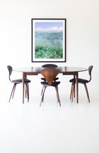 Load image into Gallery viewer, Stylish dining area featuring the Framed Coastal Wall Art - Oceana II that captures the tranquil essence of the ocean, enhancing the minimalist decor.