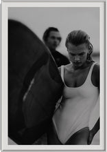 Load image into Gallery viewer, Euphoria Waves by Addison Jones Studio - a striking black-and-white artwork of a female surfer, framed elegantly in a modern interior setting.