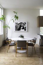 Load image into Gallery viewer, Stylish interior featuring Horse Wall Art framed in a sleek design, set above a modern dining table surrounded by elegant chairs and greenery.