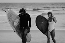 Load image into Gallery viewer, Black and white photograph of two surfers walking on the beach, showcasing dynamic surf art perfect for surf wall art enthusiasts.
