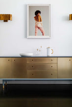 Load image into Gallery viewer, A beautifully framed portrait photography titled "Tangerine" displayed on a gold-accented sideboard, capturing a stylish model by Addison Jones Studio.