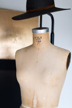 Load image into Gallery viewer, Contemporary Art-Abundance 904 displayed alongside a chair, emphasizing its minimalist aesthetic which is a hallmark of modern gold contemporary art.