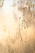 Load image into Gallery viewer, Artistic close-up of the 'Let Go' contemporary art, focusing on the gold surface and intricately inscribed lettering.