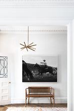 Load image into Gallery viewer, Stylish modern living space featuring 'Gallant Gallup' by Addison Jones Studio, a dramatic black and white photograph of a cowboy riding a horse, adding depth to the interior.