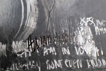 Load image into Gallery viewer, Detail-oriented view of a street art collage, emphasizing the delicate interplay of light and shadow in the artistic expression.