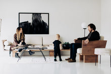 Load image into Gallery viewer, A cozy living room with a family seated around, showcasing the 'Mop Head 8120' wild horse art photograph by Addison Jones Studio on the wall.