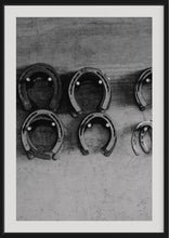 Load image into Gallery viewer, Limited Edition Western Art - Shoe Store 0217 Hand-Signed Artwork presented in a black frame, featuring well-arranged horseshoes against a textured background.
